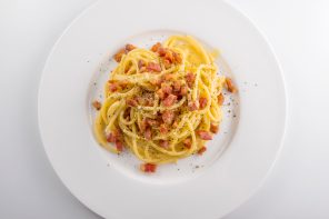 Top view of White round plate of spaghetti carbonara pasta