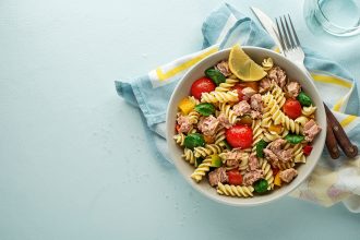 Pasta salad with tuna fish and vegetables. Healthy pasta meal. Seafood.